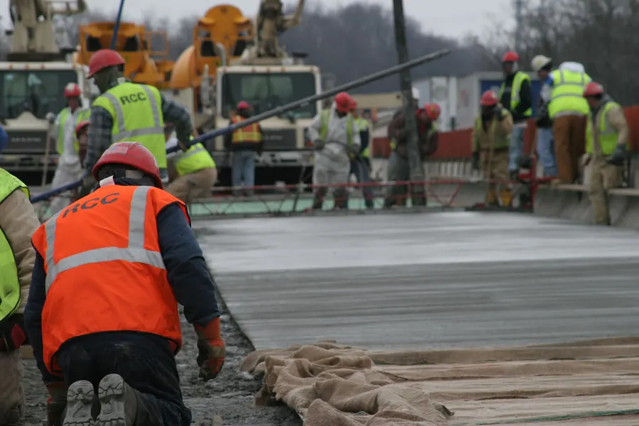 Crew finishing a concrete bridge deck pour